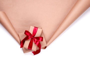 Gifts with red ribbon on the paper scroll. place for text. White background.
