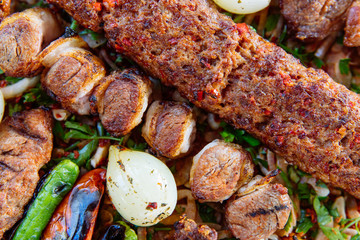Traditional Turkish Adana kebab or kebap meat food, appetizers, raki and salgam on table from top view in turkish restaurant.	