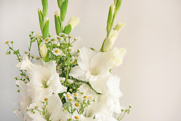 Bouquet of white gladioli. Whiteness delicate gladiolus flowers. Close up, white background