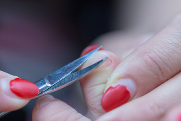 mom cuts baby's nails with protective scissors