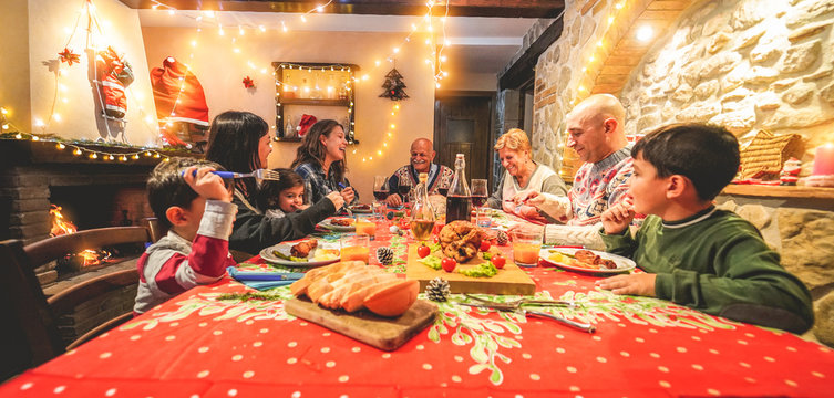 Large Multi Generation Family Having Fun At Christmas Dinner Party - Winter Holiday Xmas Concept With Grandparents, Parents And Children Eating Together At Home - Focus On Grandpa Face