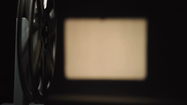 Video of film projector filming on black background