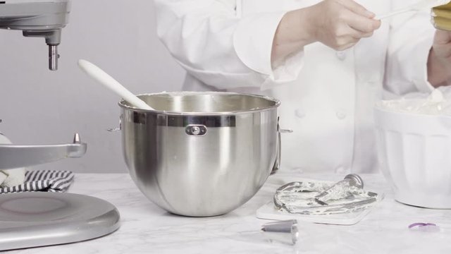 Step by step. Mixing ingredients in standing kitchen mixer to make buttercream frosting.