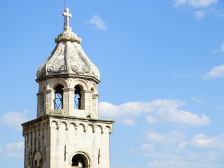 Fototapeta premium The close up of Saint Dominic Church bell tower in blue sky background, in old town Dubrovnik, Croatia.