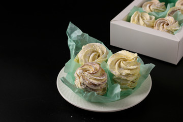 Homemade zephyr and marshmallows in a box on a dark background, Closeup