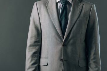 Cropped view of man in suit isolated on grey