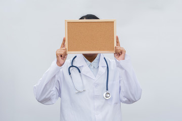 profession doctor in white coat over white isolated background with white blank board. Concept of healthcare, science and medicine concept
