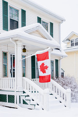 Canadian flat hanging of the front porch of a traditional older family.