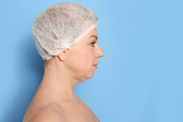 Mature woman with double chin on blue background. Space for text - obrazy, fototapety, plakaty
