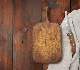 very old empty wooden rectangular cutting board and knife, top view