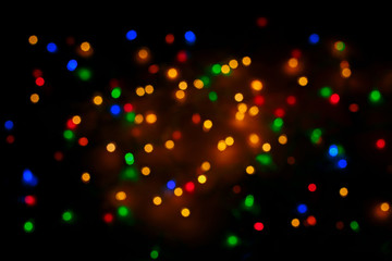 Festive Christmas background with defocused color lights