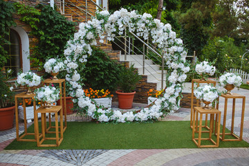 Decor for events from natural flowers, white orchid and wooden elements.