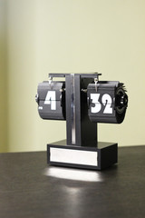 Clock on the wooden table in the room