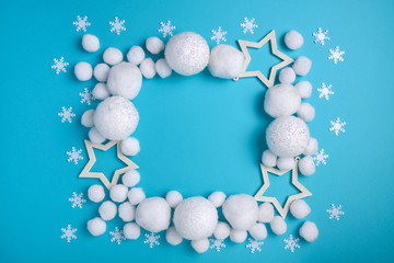 Christmas, New Year curb flat lying with white balls and snow, stars and Christmas decor. Christmas pattern on a light blue background
