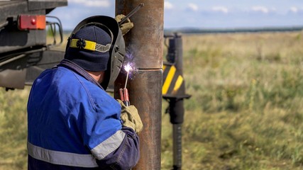 Worker. Metal welding. The construction of metal.