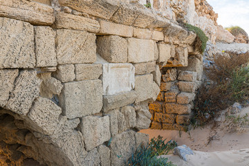 A marble  slab with an inscription in Latin on the ruins of a Roman aqueduct near Caesarea in northern Israel