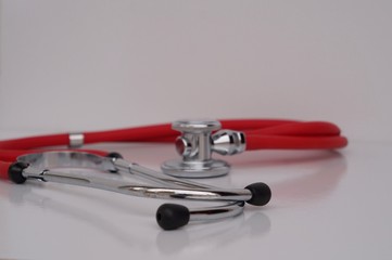 Red Stethoscope on white background.