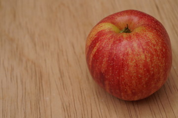 Close up of red apple on wood table background.
