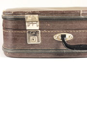 Vintage things concept. Old leather brown suitcase on white background closeup with copy space for text.