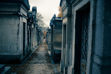 Fototapeta premium Paris, France - November 18, 2019: Graves and crypts in Pere Lachaise Cemetery, This cemetery is the final resting place for many famous people