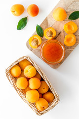 Friut background with apricot jam on white background top view