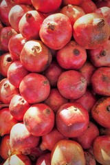 close up of pomegranates on display at the market