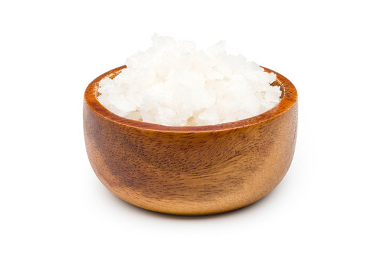 Sea salt in wooden bowl on a white background with clipping path.