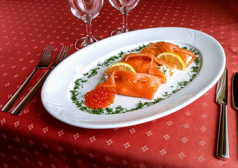 Salmon pouches with red caviar and lemon slices