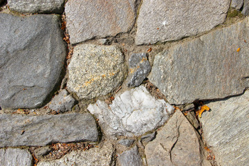 Closeup of an old pavement cobbled with natural rocks