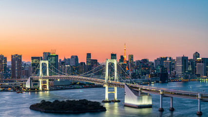 Fototapeta na wymiar Panorama beautiful view of Rainbow Bridge, Tokyo Tower and tokyo downtown skyline in evening pastel sky and twilight scene with cityscape at Odaiba Japan.