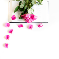 Pink Bible flat lay with: pink rose petals, open Bible, pearls. White and bright with space for text