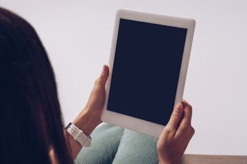 cropped view of woman using digital tablet with copy space, isolated on grey