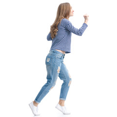 Woman in jeans and vest smile sneaking up on white background isolation