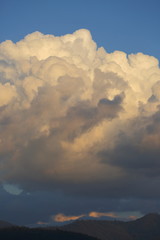 landscape image, large cloud on sky above mountain hill