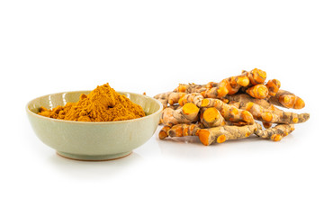 fresh turmeric root and turmeric powder in spoon on white background