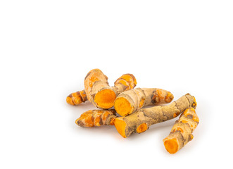 fresh turmeric root and turmeric powder in spoon on white background
