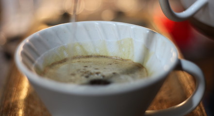 A white coffee mug on a wooden platform