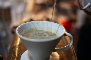 A white coffee mug on a wooden platform