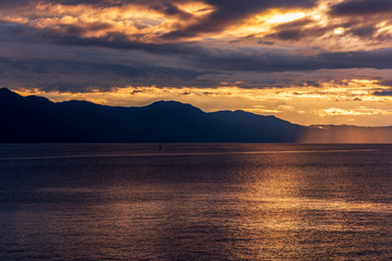 View of ocean sunset over mountains in beautiful British Columbia. Canada.