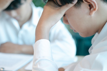 Fototapeta premium business man sitting at table in office feeling tired and stressed when investment loss, investment concept, success concept