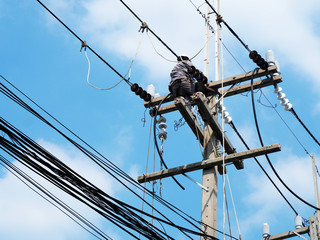electrician man working at height and dangerous ,high voltage power line maintenance