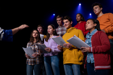 Teenagers rehearsing in a theatre