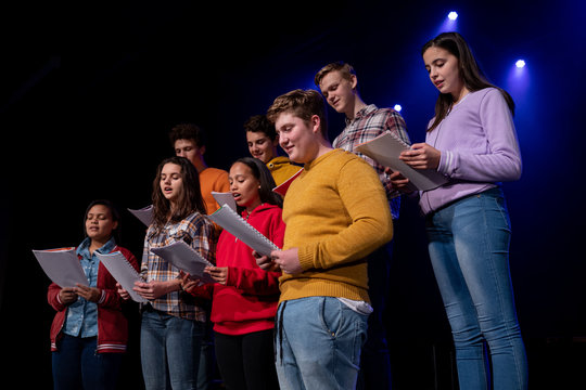 Teenagers rehearsing in a theatre