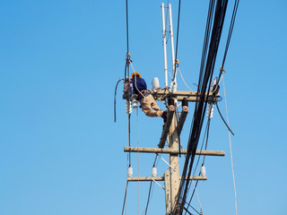 electrician man working at height and dangerous ,high voltage power line maintenance