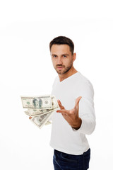 Portrait of young businessman throwing out money banknotes isolated on white background