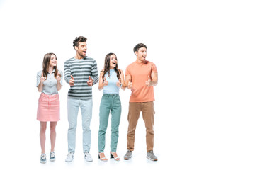 Fototapeta premium excited friends shouting and showing thumbs up isolated on white