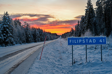 road sign near winter road through Varmland Sweden