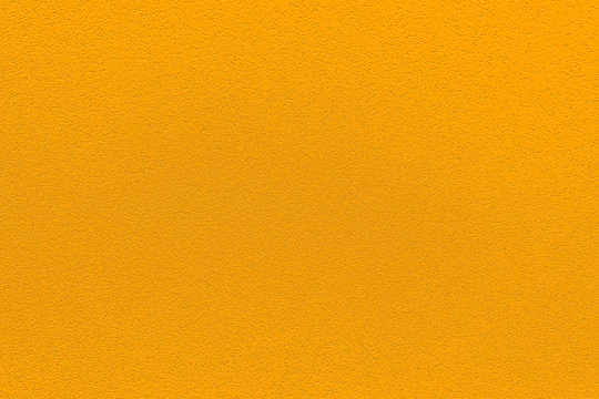 Fashionable saffron pantone color of spring-summer 2020 season from New York fashion week. Texture of colored porous rubber. Modern luxury background or mock up with space for text