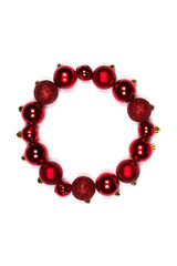 Round frame in form of Christmas wreath of New Year's red balls. Layout for design flat lay, place for text. Christmas balls of different sizes and textures. Merry Christmas and a happy new year.