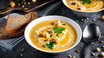 Homemade autumn pumpkin soup with bread